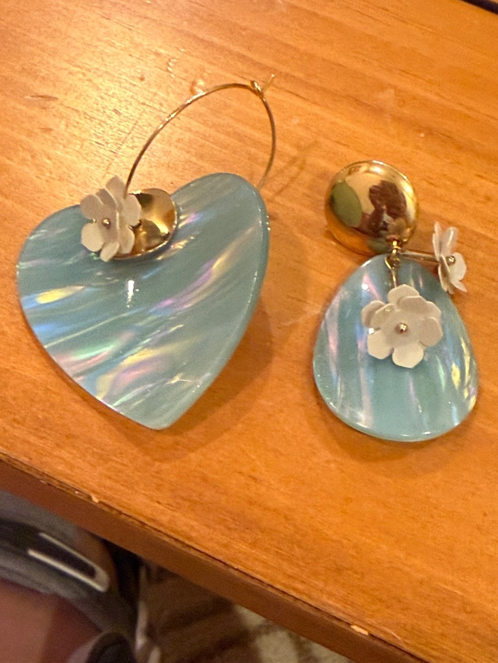 Acrylic and gold are mismatched earrings